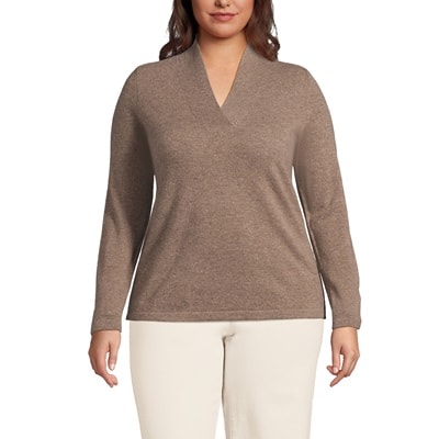 A woman wearing a light brown sweater and beige pants
