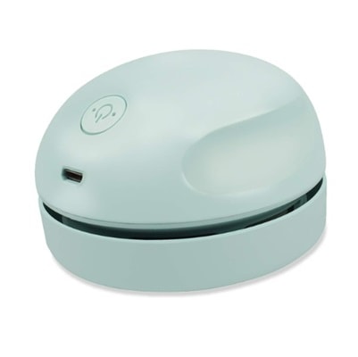 A round, light-green mini desktop vacuum cleaner