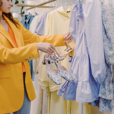 woman in yellow blazer with orange top shops for clothes to step up her work wardrobe