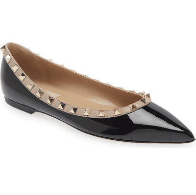 black patent flat with beige and gold rockstud detailing around the mouth of the shoe